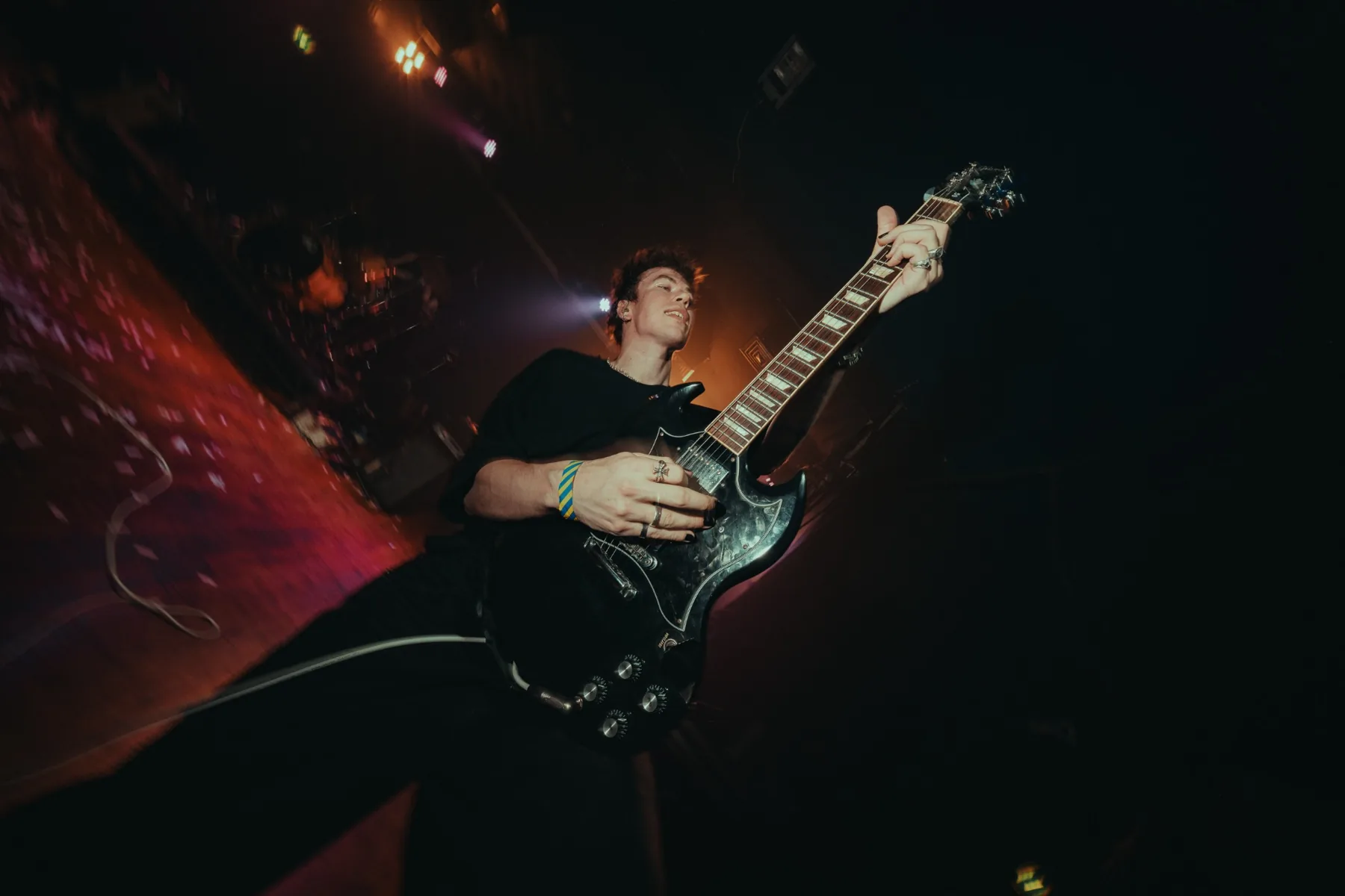 Zack Borg playing guitar on stage